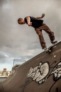 Man Riding Skateboard While Performing Stunts